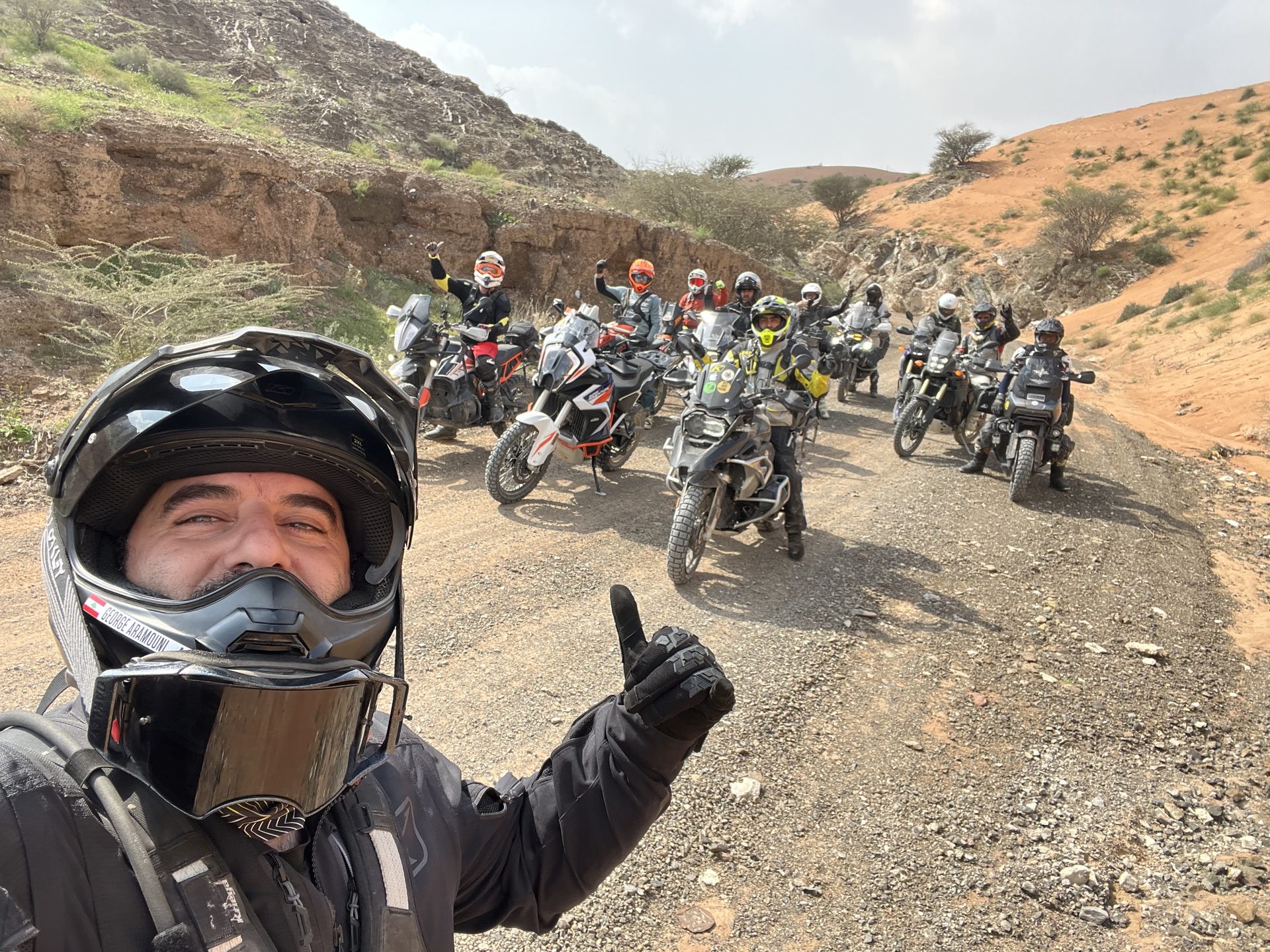GOT riders greeting the camera on a Hajar trail