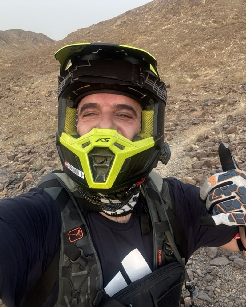 George taking a helmet selfie on a rocky Hajar trail